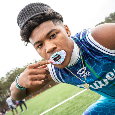 Lifestyle Image of Youth 7v7 Football Player Wearing 3D Iridescent Max AirFlow Football Mouthguard