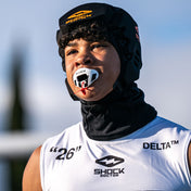 Lifestyle Image of Youth 7v7 Football Player Wearing Shock Doctor 3D Stripes Max AirFlow Football Mouthguard (White/Black)