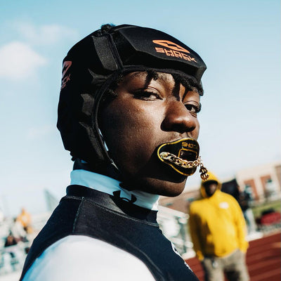 Youth Football Player Wearing Shock Doctor 3D Chain Jewel Max AirFlow Football Mouthguard (Black/Gold Money)