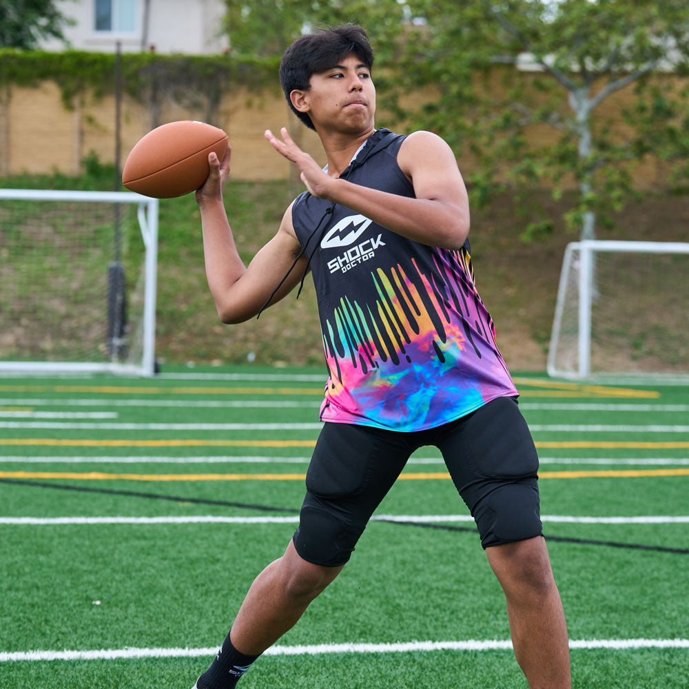 Lifestyle Image of Youth Football Player Wearing Shock Doctor Tie Dye Performance Sleeveless Hoodie