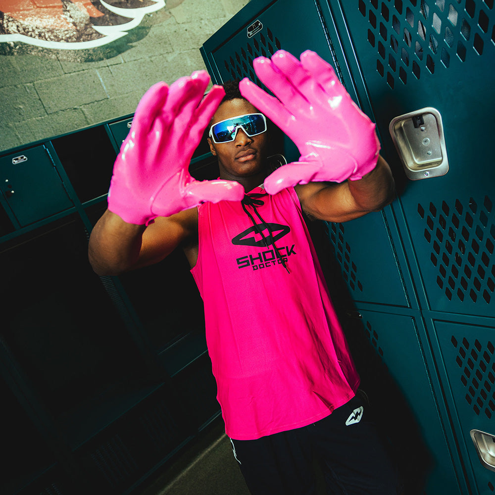 Youth 7v7 Athlete Wearing Shock Doctor Performance Sleeveless Hoodie in Shock Pink