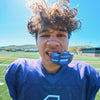 Youth Tackle Football Player Wearing Shock Doctor Kool Aid Max AirFlow Football Mouthguard (Grape Flavor)