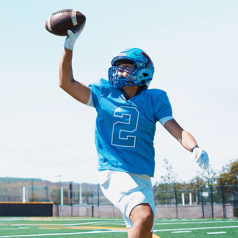 Youth Tackle Football Player Wearing Shock Doctor Kool Aid Max AirFlow Football Mouthguard (Tropical Punch Flavor)