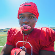 Lifestyle Image of Youth Tackle Football Player Wearing Shock Doctor Warheads Sour Watermelon Max AirFlow Football Mouthguard