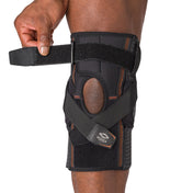 Shock Doctor Hyperlite Knee Brace with Heavy Duty Hinges - On-Body - Athlete using Adjustable Strap for Better Fit