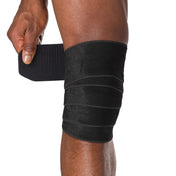 HyperWrap Multi-Use Compression Wrap by Shock Doctor shown in black, providing adjustable support for wrist and knee with wrap-around design.