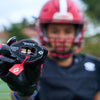 Youth Tackle Football Player Showcasing Shock Doctor 3D Stitch Max AirFlow Football Mouthguard (Black/Red)