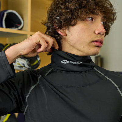 Lifestyle Image of Youth Male Hockey Player Wearing Shock Doctor Ultra Compression Hockey Long Sleeve Shirt With Integrated Neck Guard