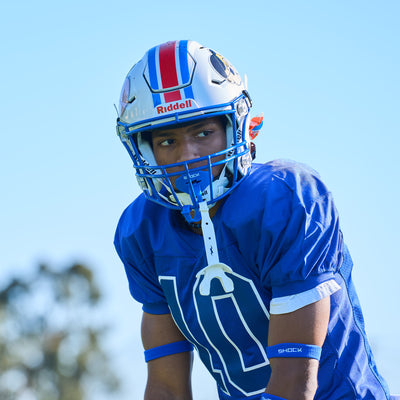 Lifestyle Image of Youth Football Player Wearing Shock Doctor Royal Blue Bolt Lip Guard/Mouthguard