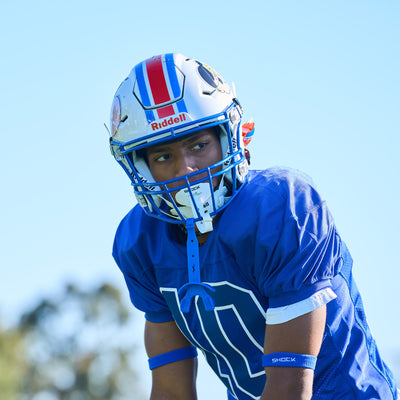 Lifestyle Image of Youth Football Player Wearing Shock Doctor White Bolt Lip Guard/Mouthguard