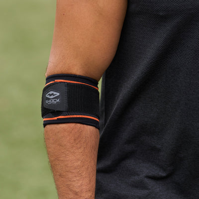 Athlete Wearing Shock Doctor Compression Knit Tennis/Golf Elbow Sleeve with Gel Support & Strap