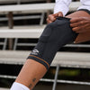 Athlete Sliding on Shock Doctor Ultra Knit Knee Support with Full Patella Gel & Stays Before Workout