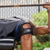 Athlete Wearing Shock Doctor Dual Strap Knee Wrap While Lifting Barbell